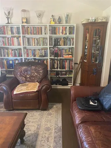 a view of an empty room with a ceiling fan window and a ceiling fan