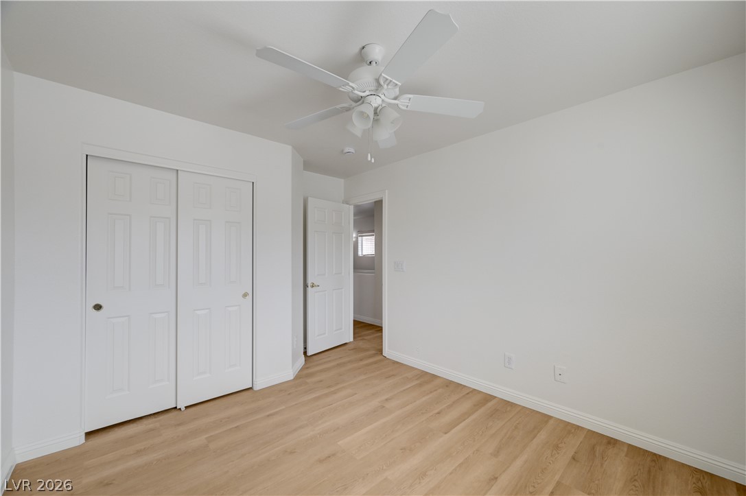 8918 Houston Ridge Avenue Las Vegas, NV 89178 - Photo 30 of 35 A pristine bedroom showcasing neutral tones and rich plank flooring.
