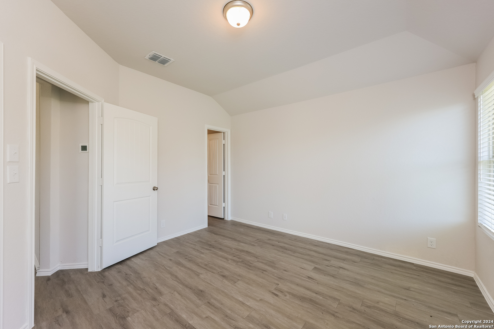10702 Apple Pie Road San Antonio, TX 78224 - Photo 11 of 19 a view of an empty room with wooden floor and closet
