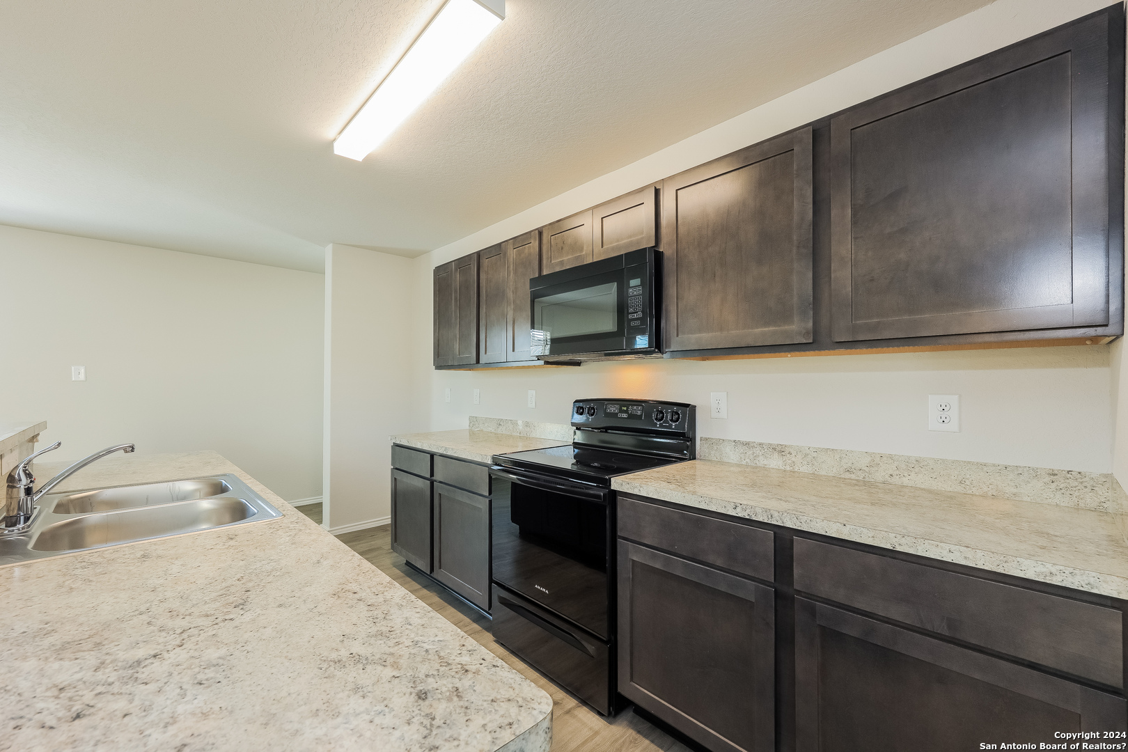 10702 Apple Pie Road San Antonio, TX 78224 - Photo 5 of 19 a kitchen with a sink stove and microwave