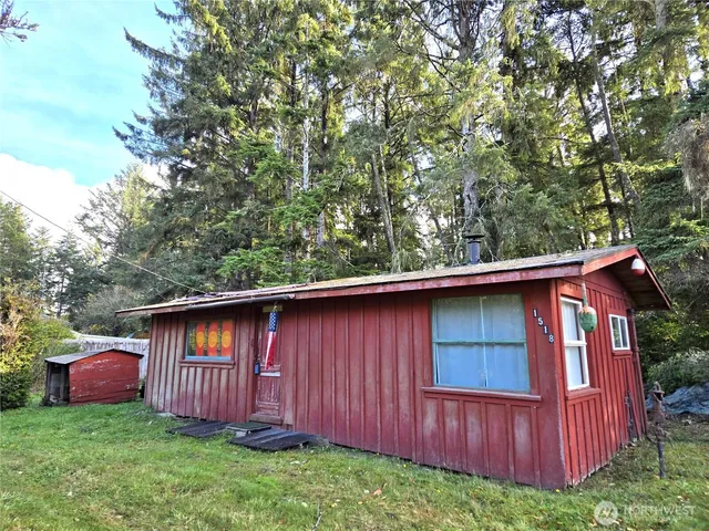 a view of backyard with barn and wooden fence