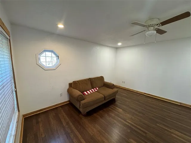 a living room with hard wood floors and a window