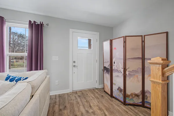 a living room with a bed and a window