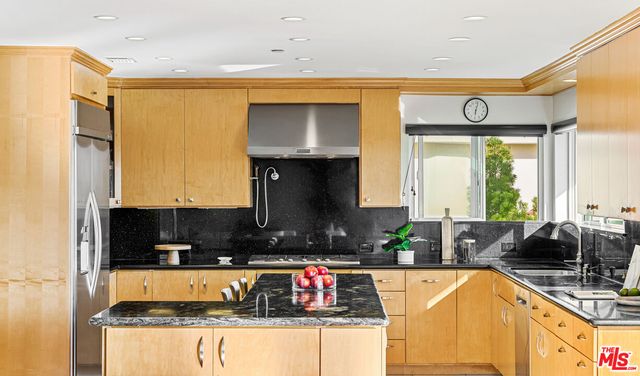 a kitchen with granite countertop a sink a counter top space and living area