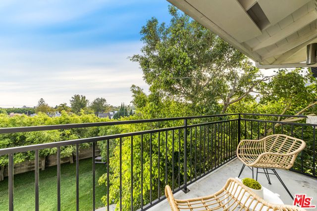 a view of a balcony with furniture