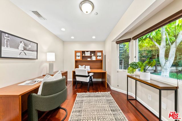 a living room with furniture a rug and a floor to ceiling window