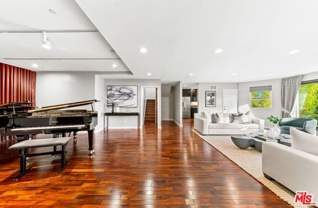 a living room with furniture wooden floor and a table