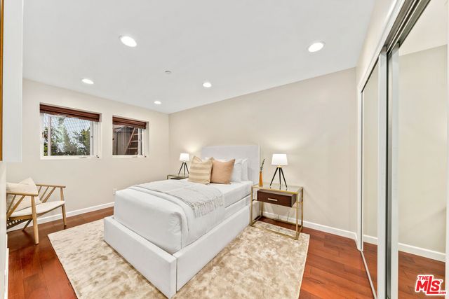 a bedroom with a large bed and a rug