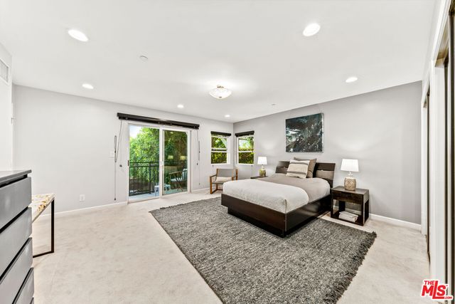 a living room with a bed furniture and a window
