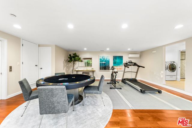 a living room with furniture and gym equipment