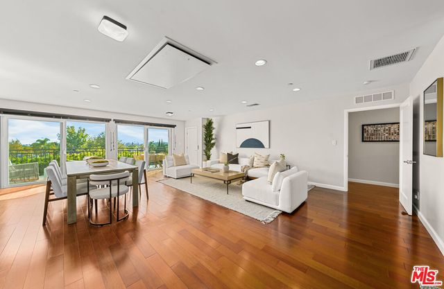 a living room with fireplace furniture and a wooden floor
