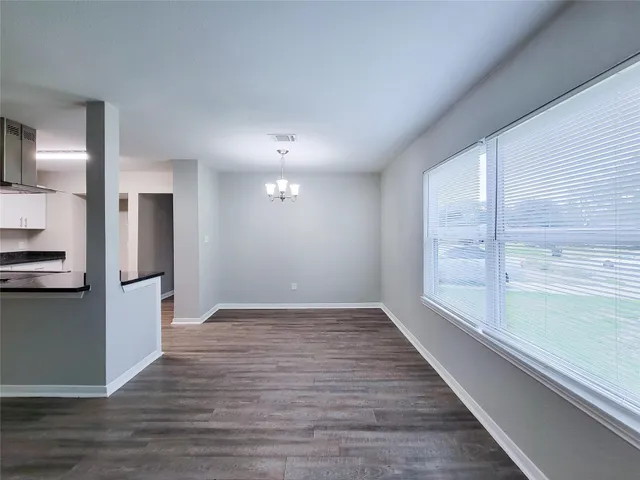 a view of a kitchen with a sink and refrigerator