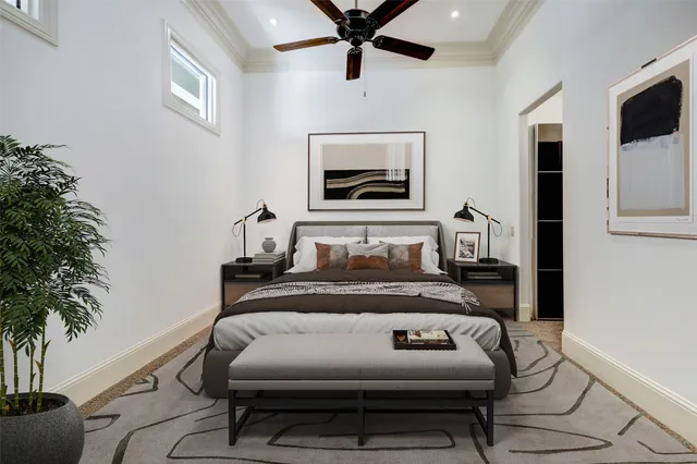 a bedroom with furniture and a potted plant