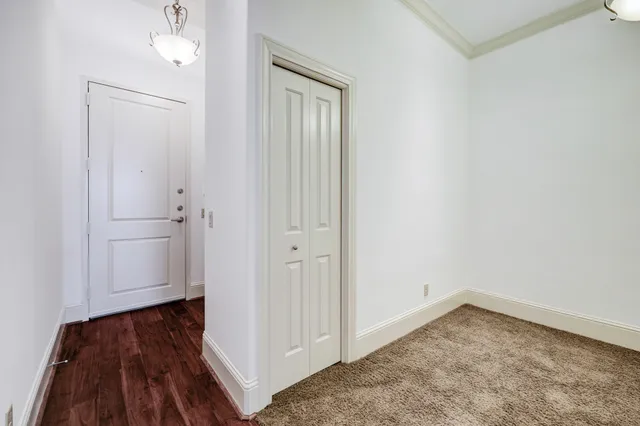 a view of a room with wooden floor and a sink