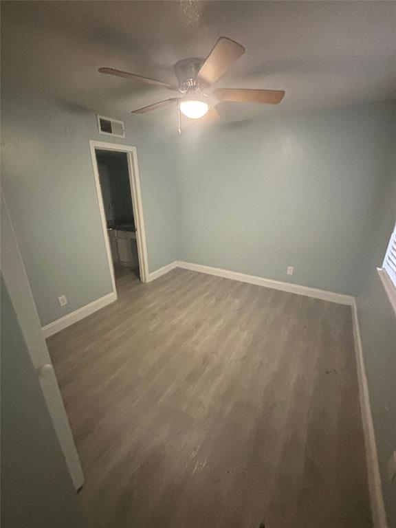 301 Rolston Road, Unit 305101 Irving, TX 75060 - Photo 4 of 7 Spacious room with wood-finish flooring, light blue walls, and white baseboards