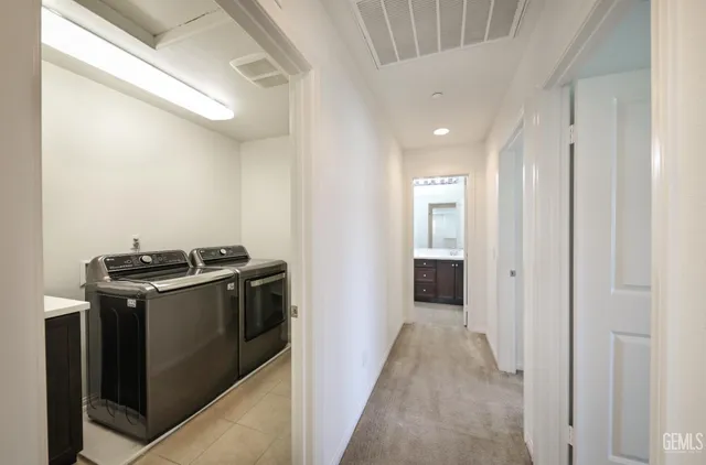 a view of a kitchen with a stove fridge and wooden floor