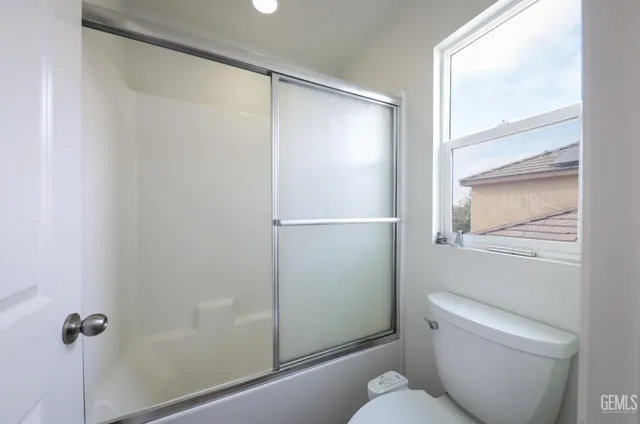 a bathroom with a shower and a toilet