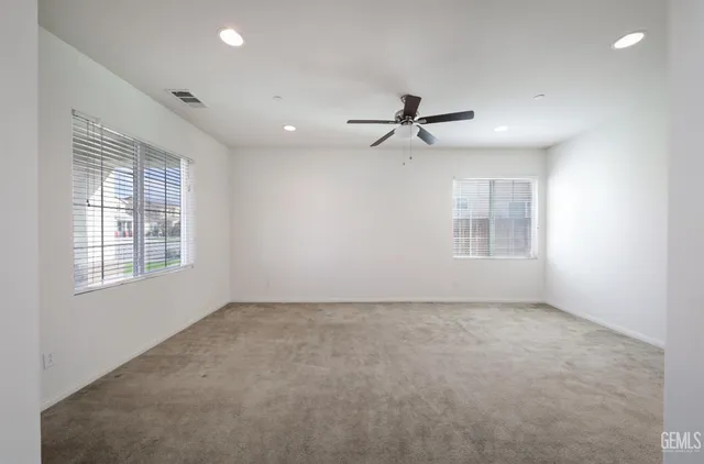 a view of room with a ceiling fan and window
