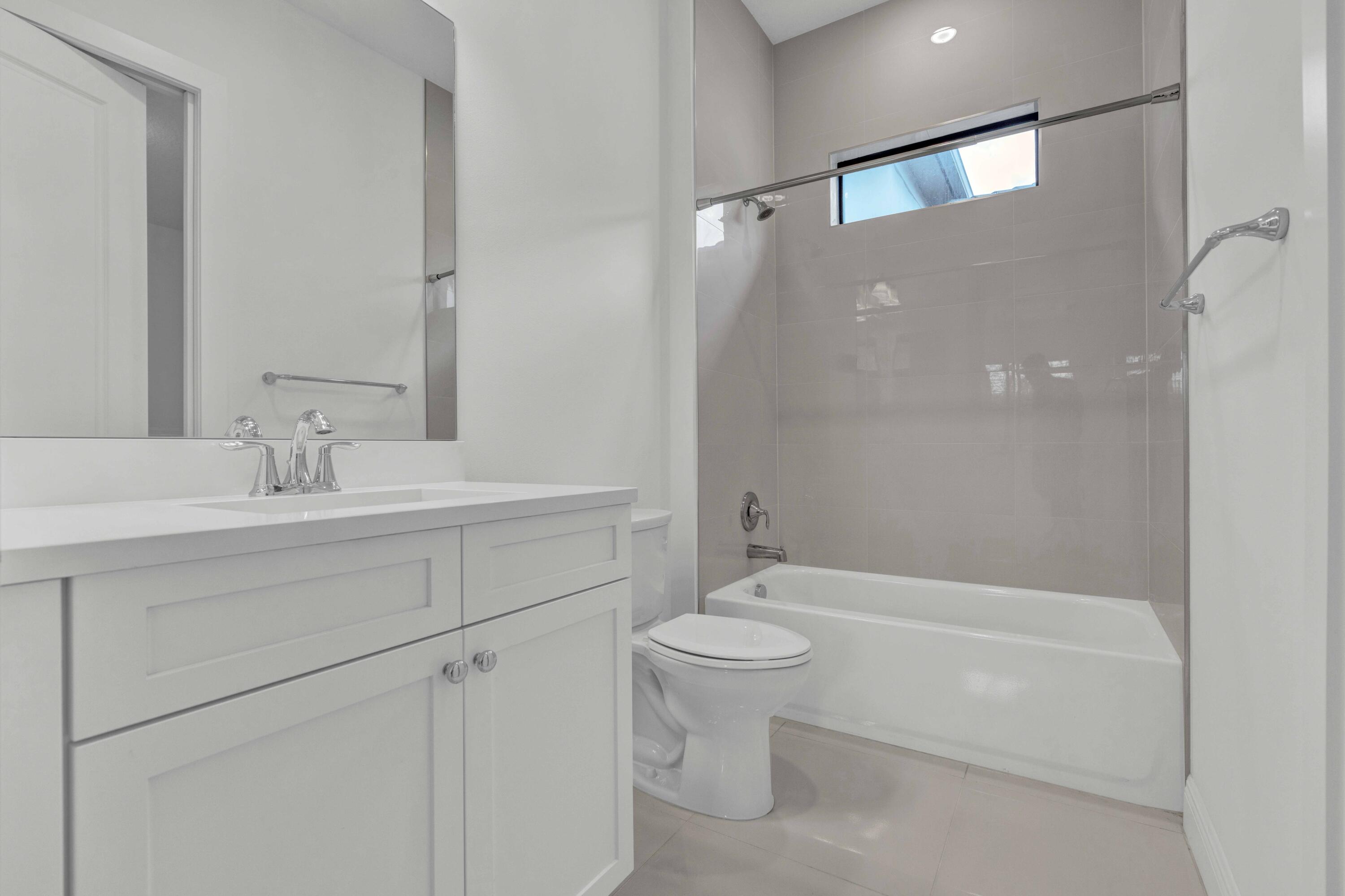 5501 Santa Rosa Lane Westlake, FL 33470 - Photo 14 of 31 a bathroom with a sink a toilet and shower