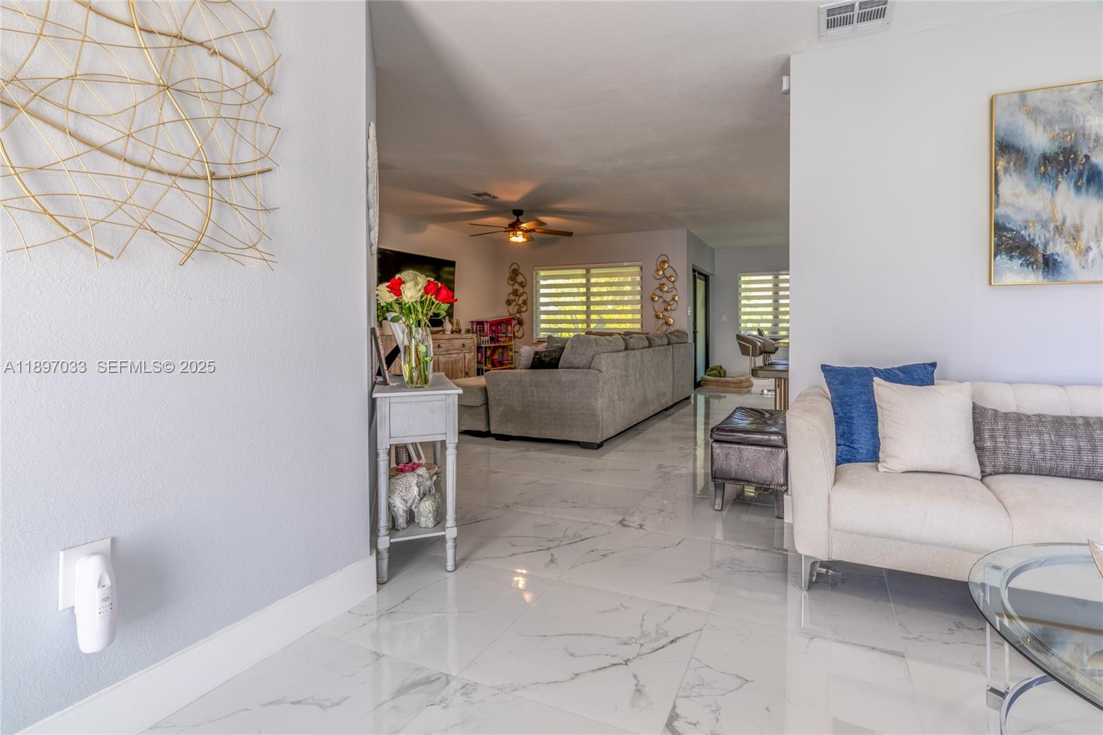 11381 Southwest 247th Terrace Homestead, FL 33032 - Photo 11 of 42 a living room with furniture and a flat screen tv