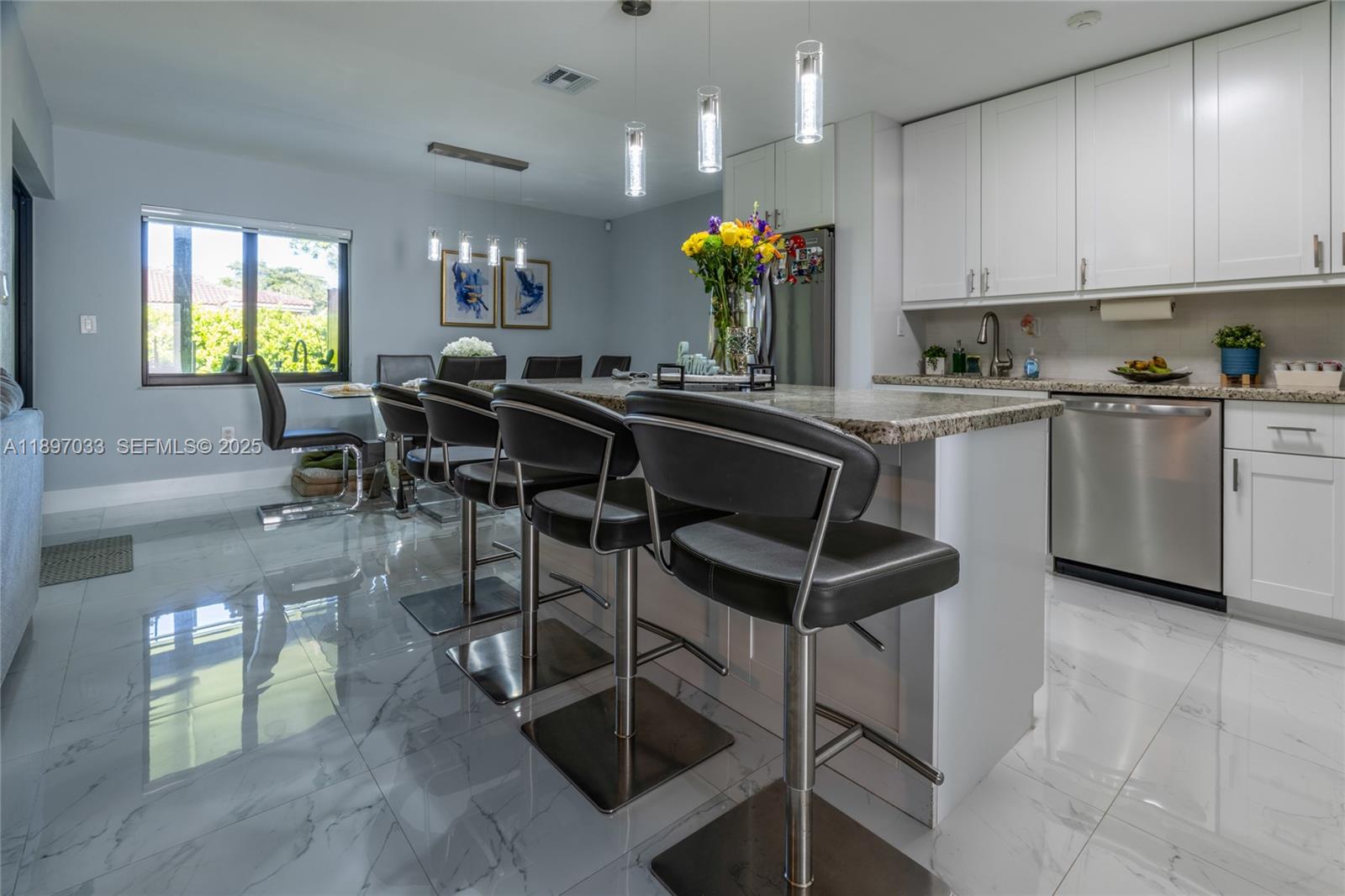 11381 Southwest 247th Terrace Homestead, FL 33032 - Photo 13 of 42 a kitchen with stainless steel appliances granite countertop table chairs sink and cabinets