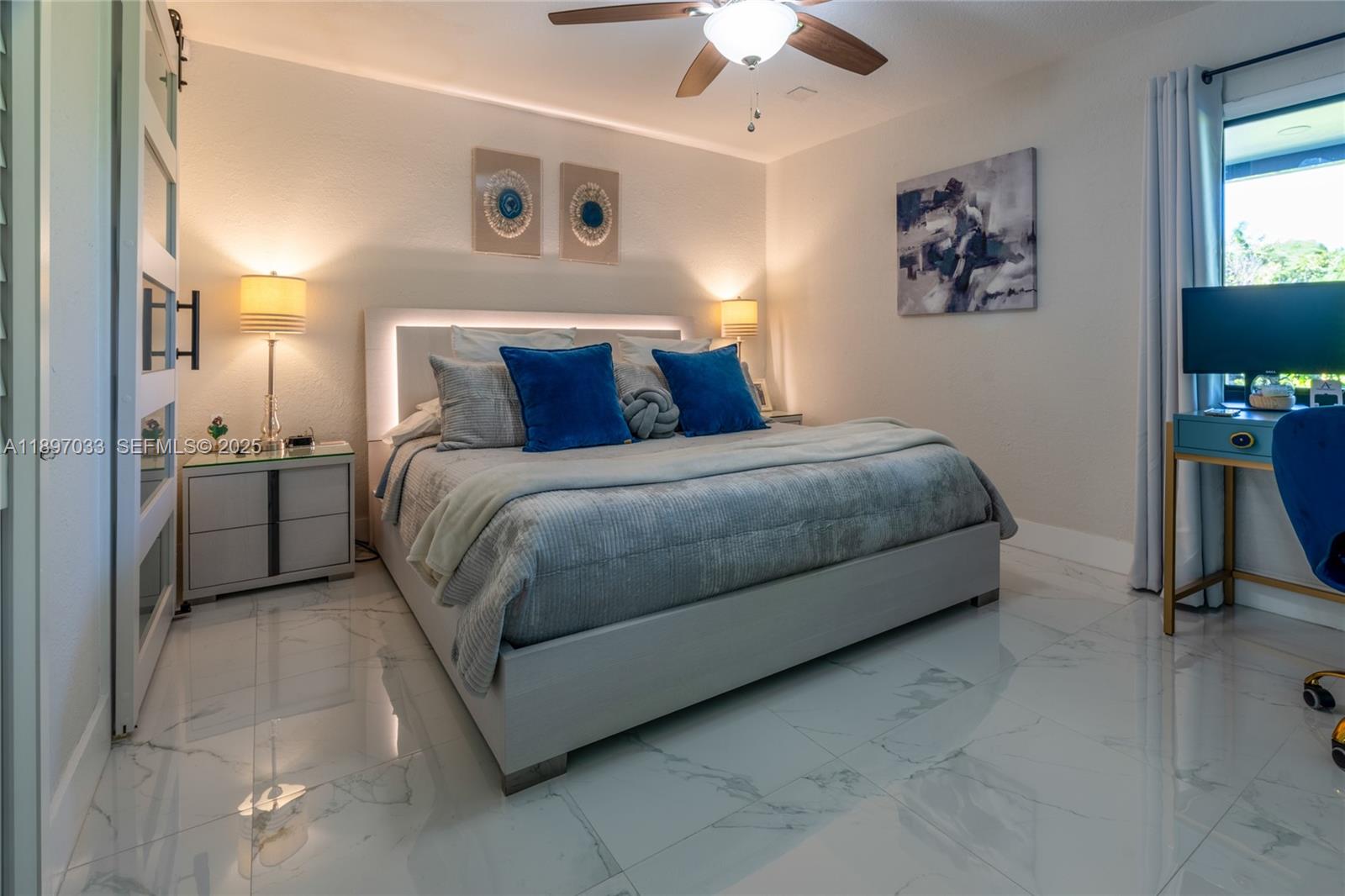 11381 Southwest 247th Terrace Homestead, FL 33032 - Photo 17 of 42 a bedroom with a bed and a chandelier