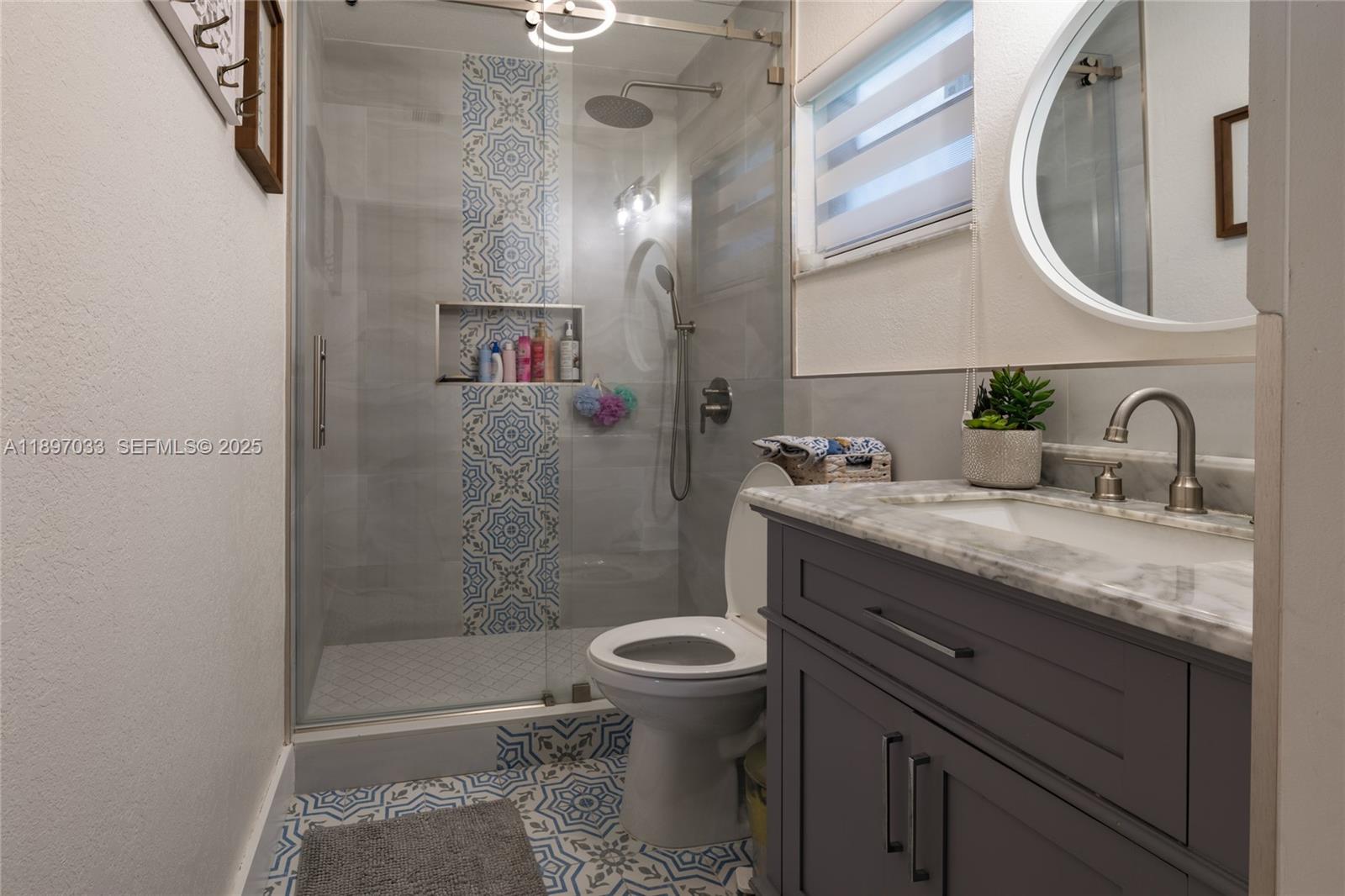 11381 Southwest 247th Terrace Homestead, FL 33032 - Photo 19 of 42 a bathroom with a granite countertop sink toilet and shower