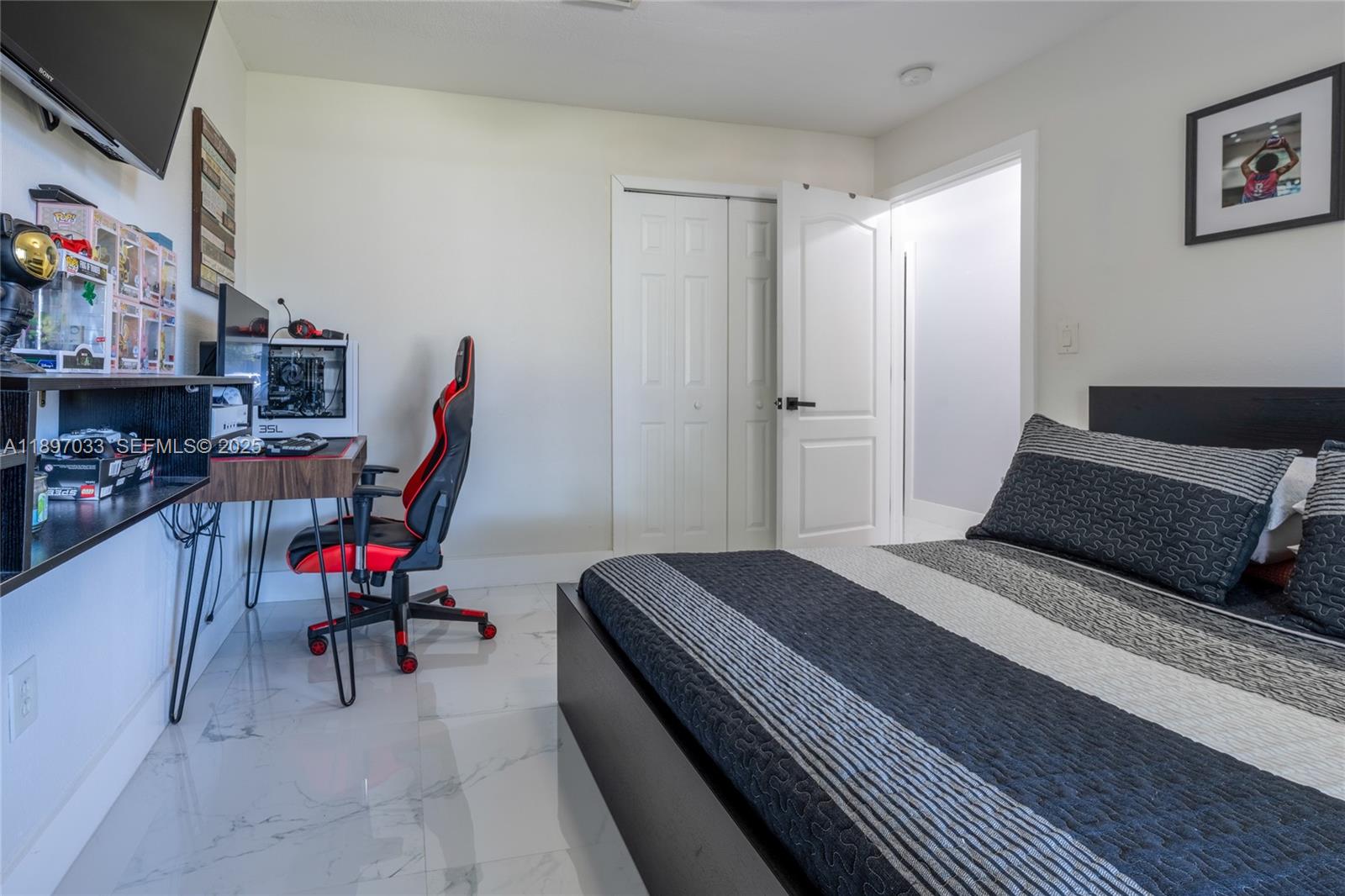 11381 Southwest 247th Terrace Homestead, FL 33032 - Photo 20 of 42 a bedroom with a bed a desk and chair