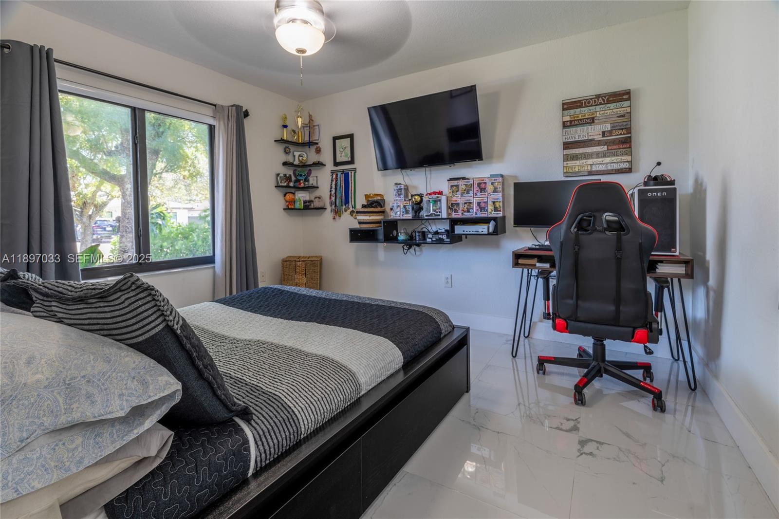 11381 Southwest 247th Terrace Homestead, FL 33032 - Photo 21 of 42 a bedroom with a bed and a flat screen tv