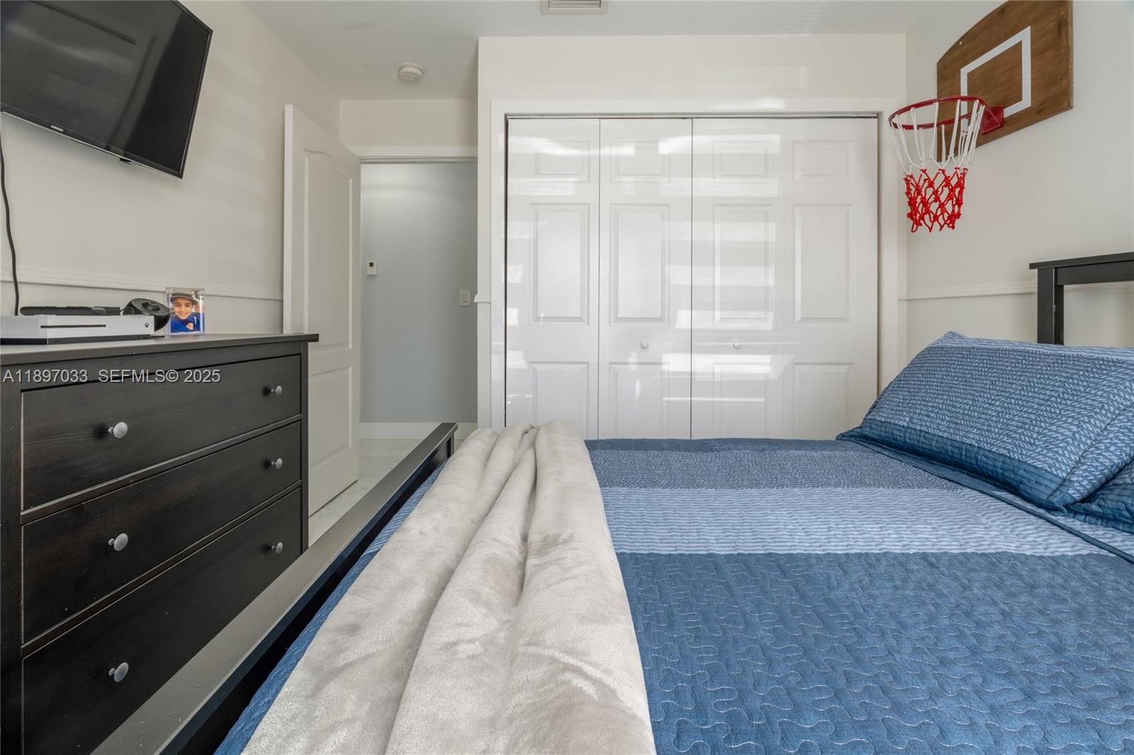 11381 Southwest 247th Terrace Homestead, FL 33032 - Photo 25 of 42 a hallway with a couch and a flat screen tv