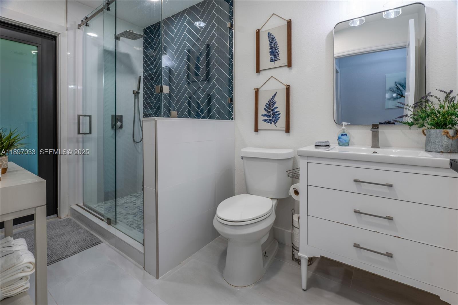 11381 Southwest 247th Terrace Homestead, FL 33032 - Photo 26 of 42 a bathroom with a toilet sink and shower