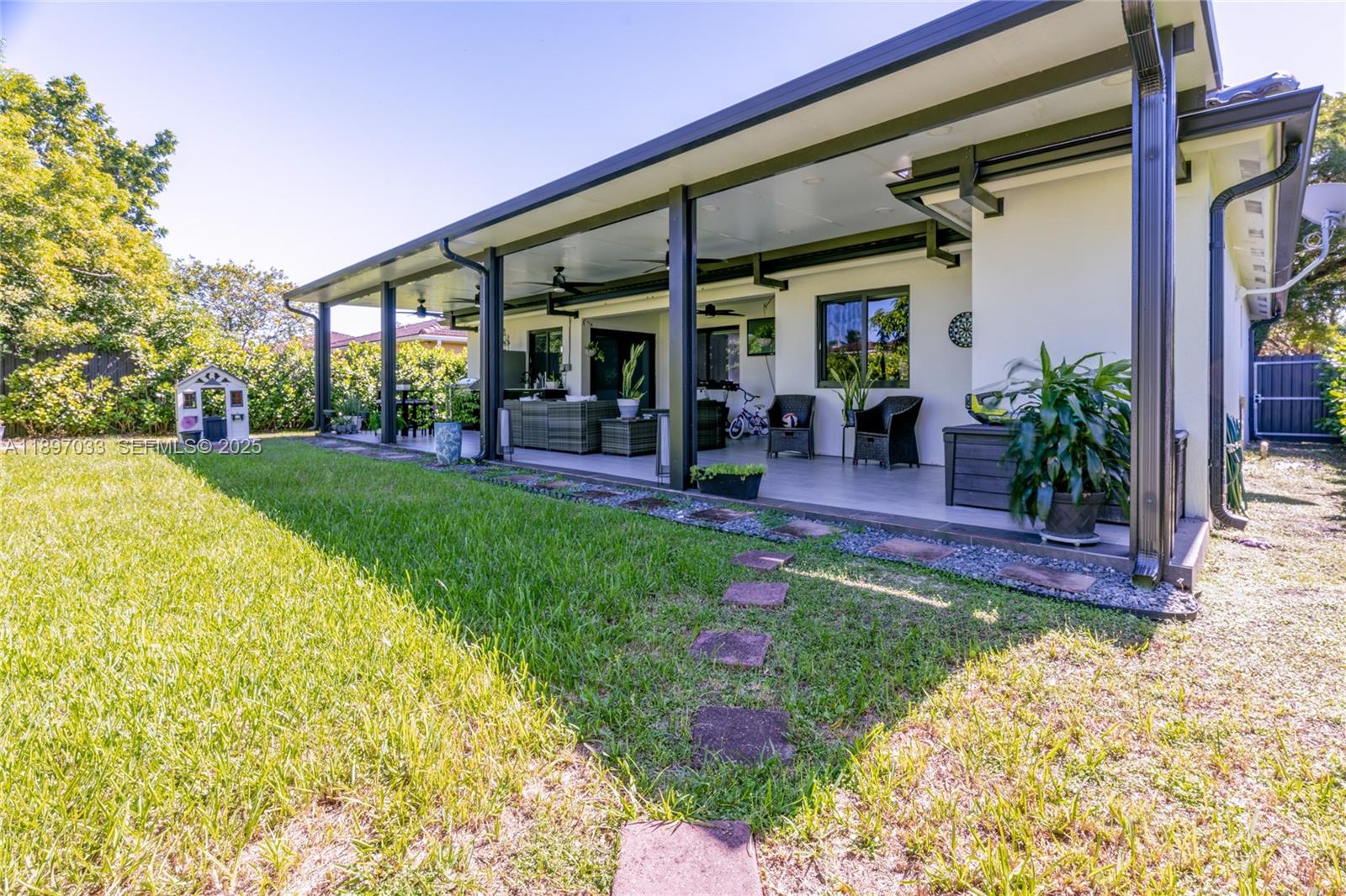 11381 Southwest 247th Terrace Homestead, FL 33032 - Photo 28 of 42 a view of a house with garden and sitting area