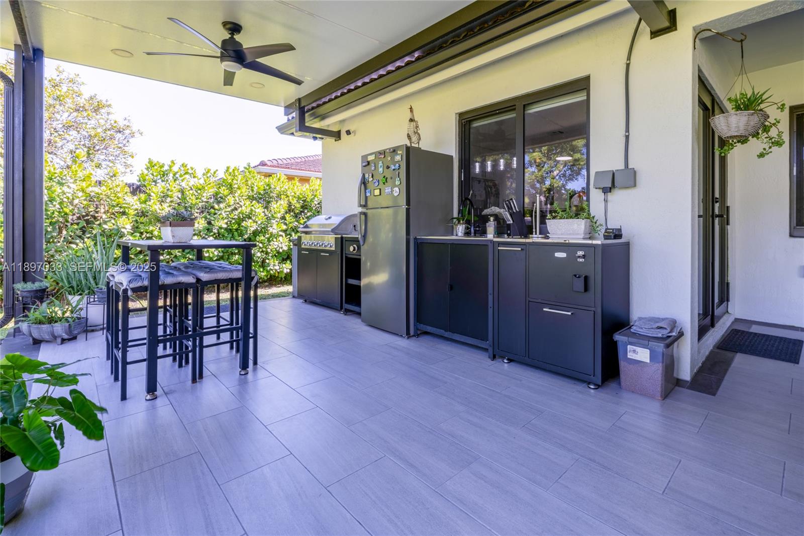 11381 Southwest 247th Terrace Homestead, FL 33032 - Photo 32 of 42 a view of a porch with chairs and table in a patio
