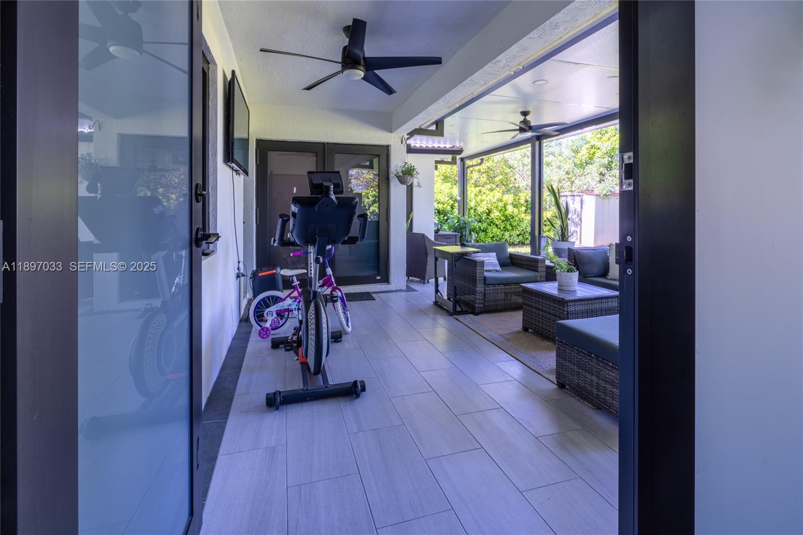 11381 Southwest 247th Terrace Homestead, FL 33032 - Photo 36 of 42 a view of a livingroom with furniture gym equipment