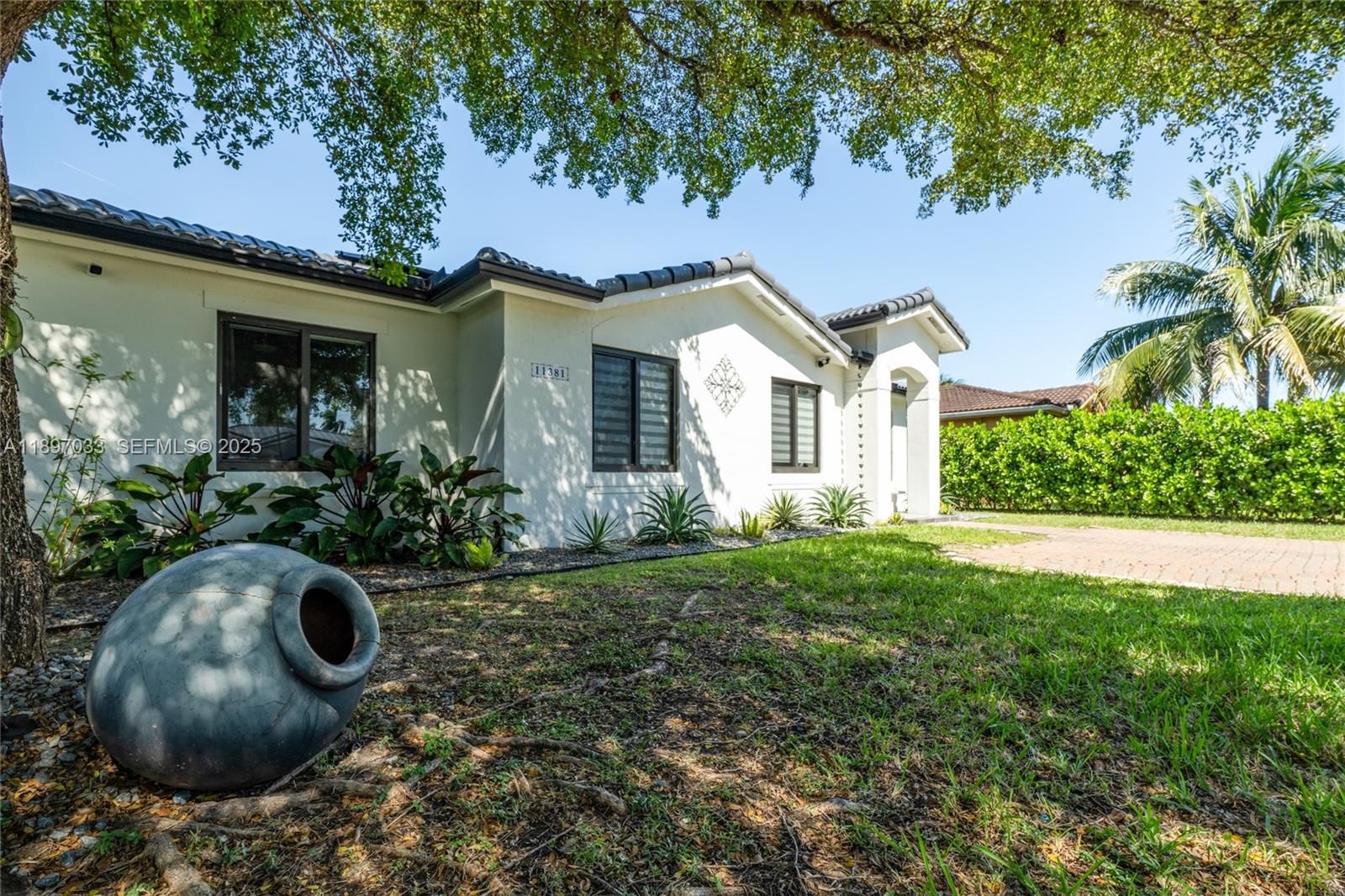 11381 Southwest 247th Terrace Homestead, FL 33032 - Photo 4 of 42 a view of a house with garden and plants