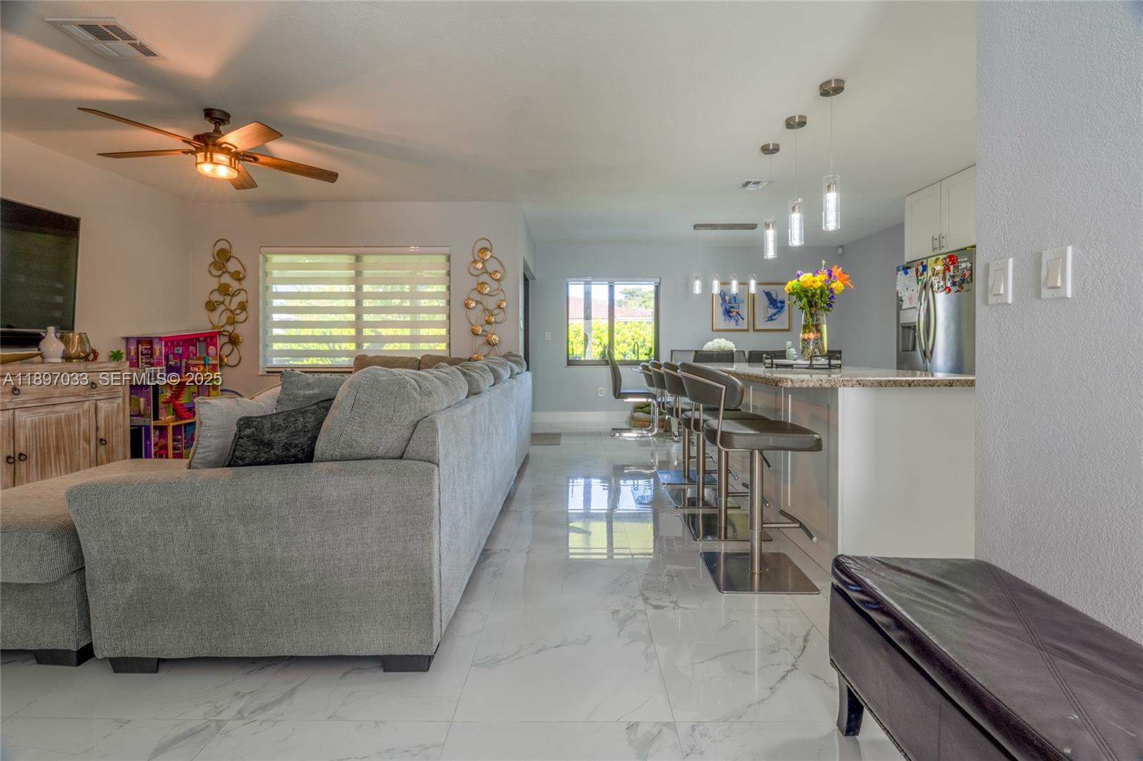 11381 Southwest 247th Terrace Homestead, FL 33032 - Photo 6 of 42 a living room with furniture and a flat screen tv