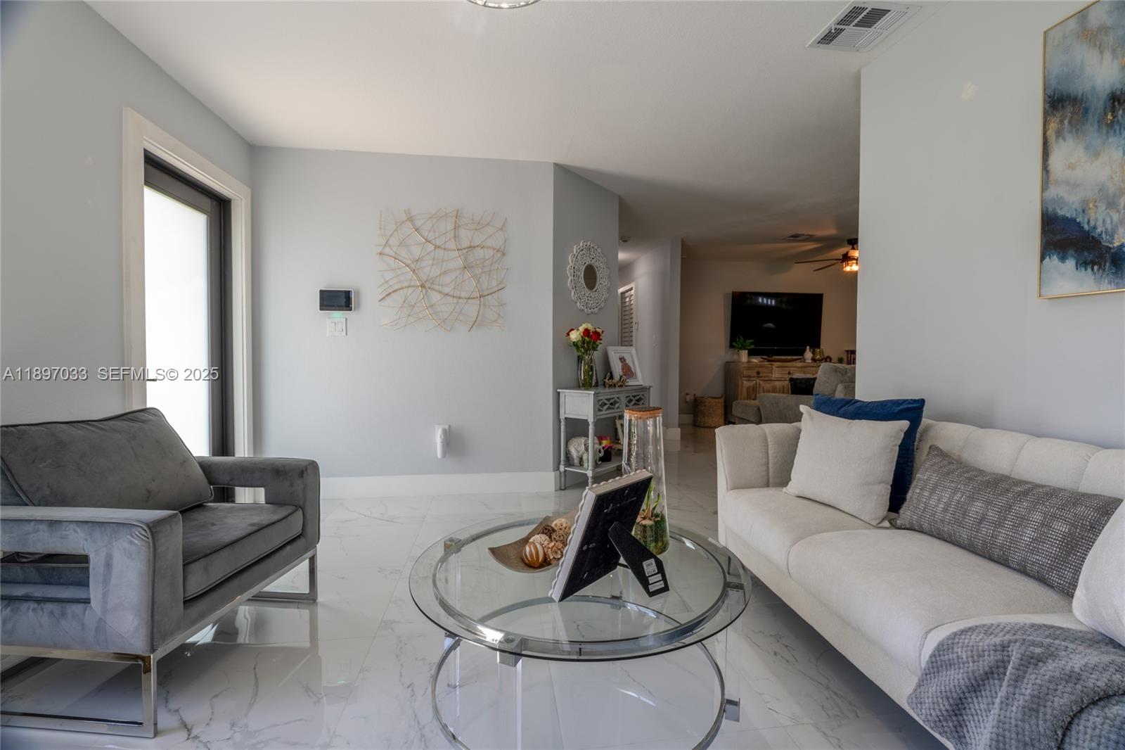 11381 Southwest 247th Terrace Homestead, FL 33032 - Photo 7 of 42 a living room with furniture and a fireplace