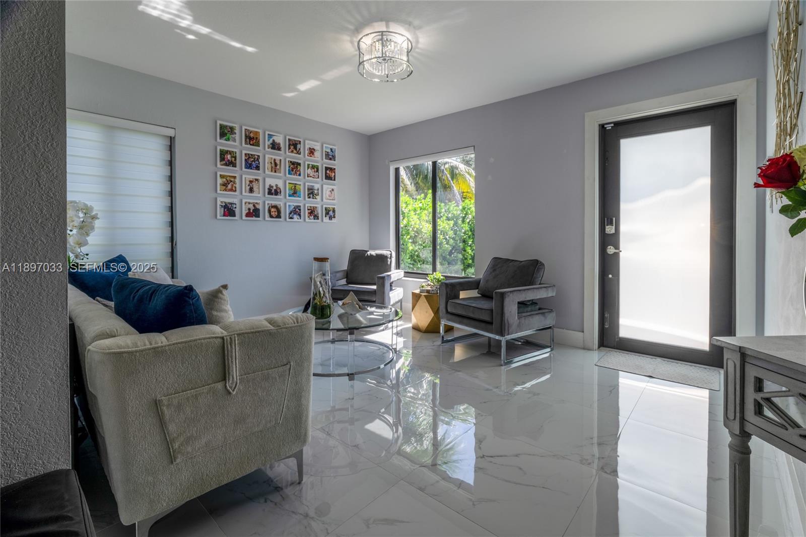 11381 Southwest 247th Terrace Homestead, FL 33032 - Photo 8 of 42 a living room with furniture and a large window