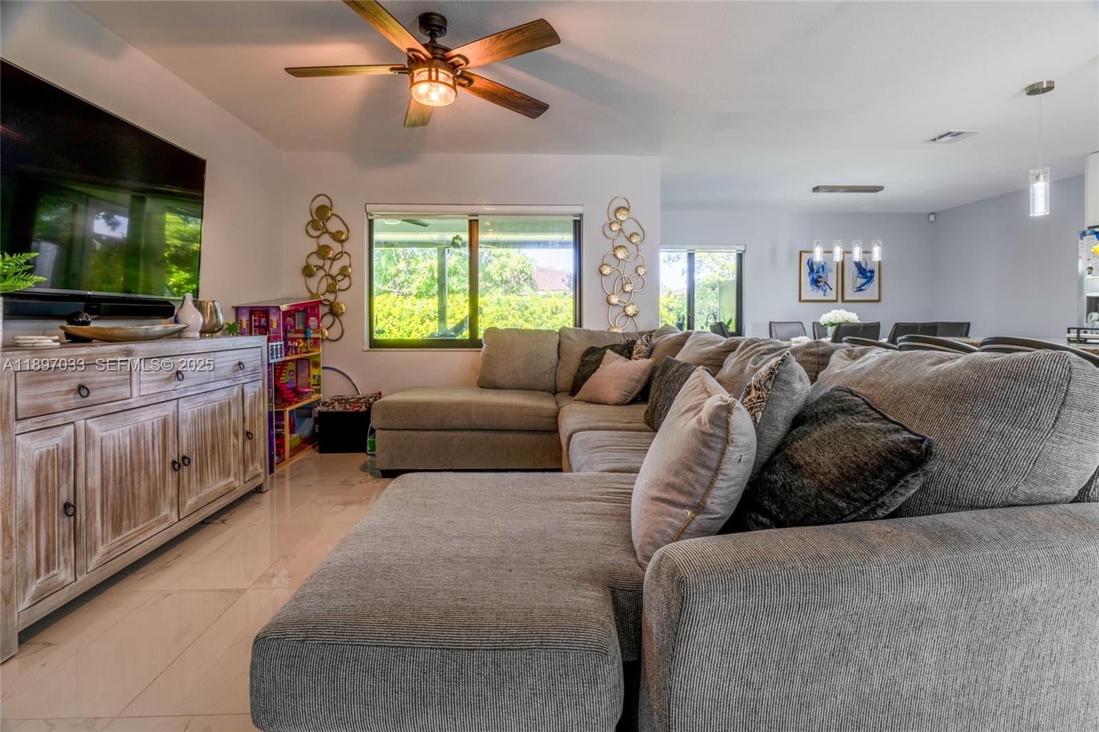 11381 Southwest 247th Terrace Homestead, FL 33032 - Photo 9 of 42 a living room with furniture and a flat screen tv