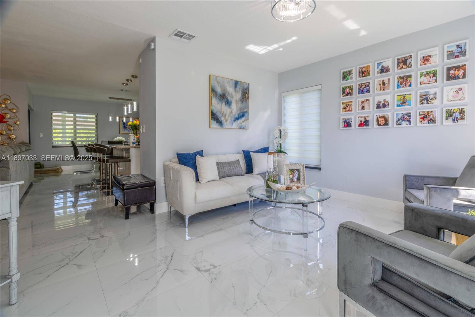 11381 Southwest 247th Terrace Homestead, FL 33032 - Photo 10 of 42 a living room with furniture and a flat screen tv
