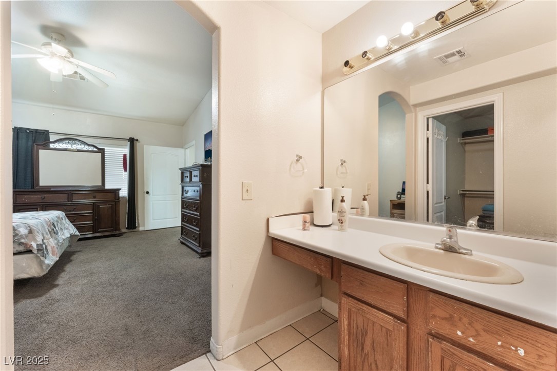 4656 East Desert Inn Road Las Vegas, NV 89121 - Photo 53 of 98 4650 E DI Bathroom featuring ceiling fan, vanity, tile patterned floors, and ensuite bath
