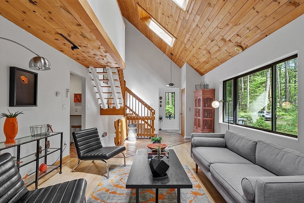 309 Littleton Road Harvard, MA 01451 - Photo 2 of 41 a living room with furniture a fireplace and a large window