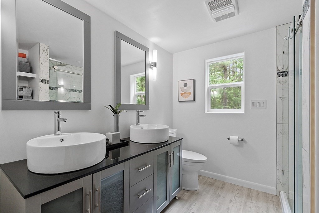309 Littleton Road Harvard, MA 01451 - Photo 27 of 41 a bathroom with a double vanity sink toilet and a mirror