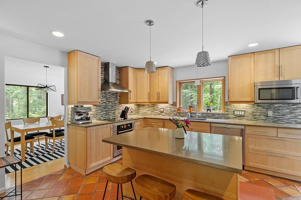 309 Littleton Road Harvard, MA 01451 - Photo 7 of 41 a kitchen with stainless steel appliances granite countertop a sink a stove and a wooden floors