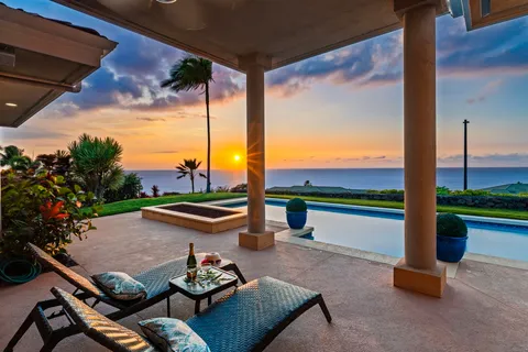 a view of a porch with furniture and a yard