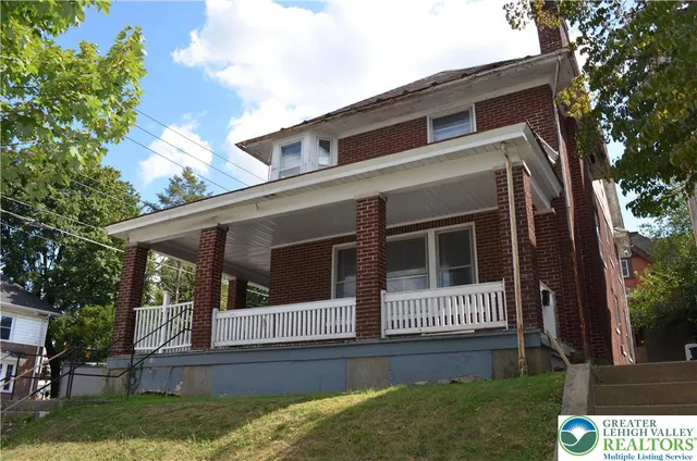 a view of front door and a yard