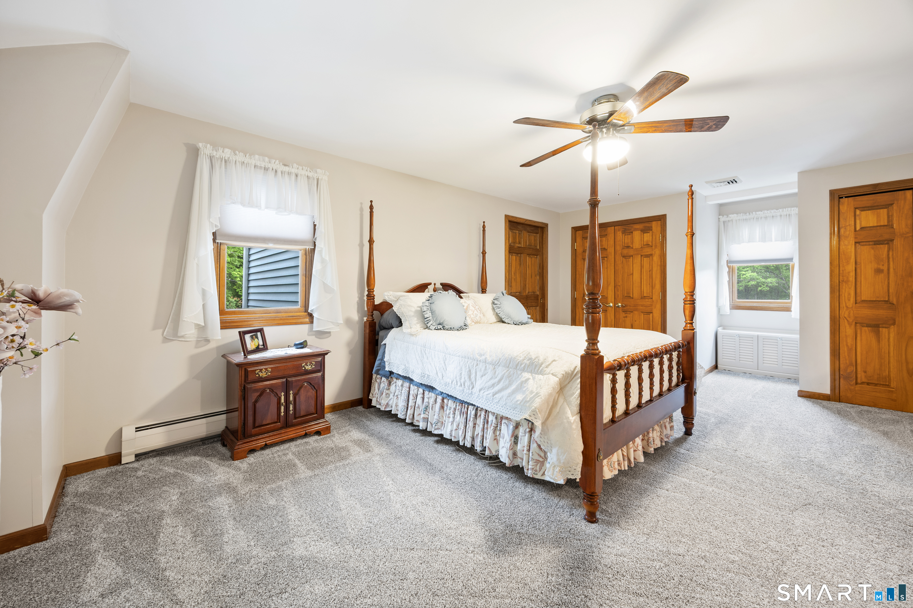 42 Chimney Sweep Road Wallingford, CT 06492 - Photo 23 of 40 a bedroom with a bed and a chandelier