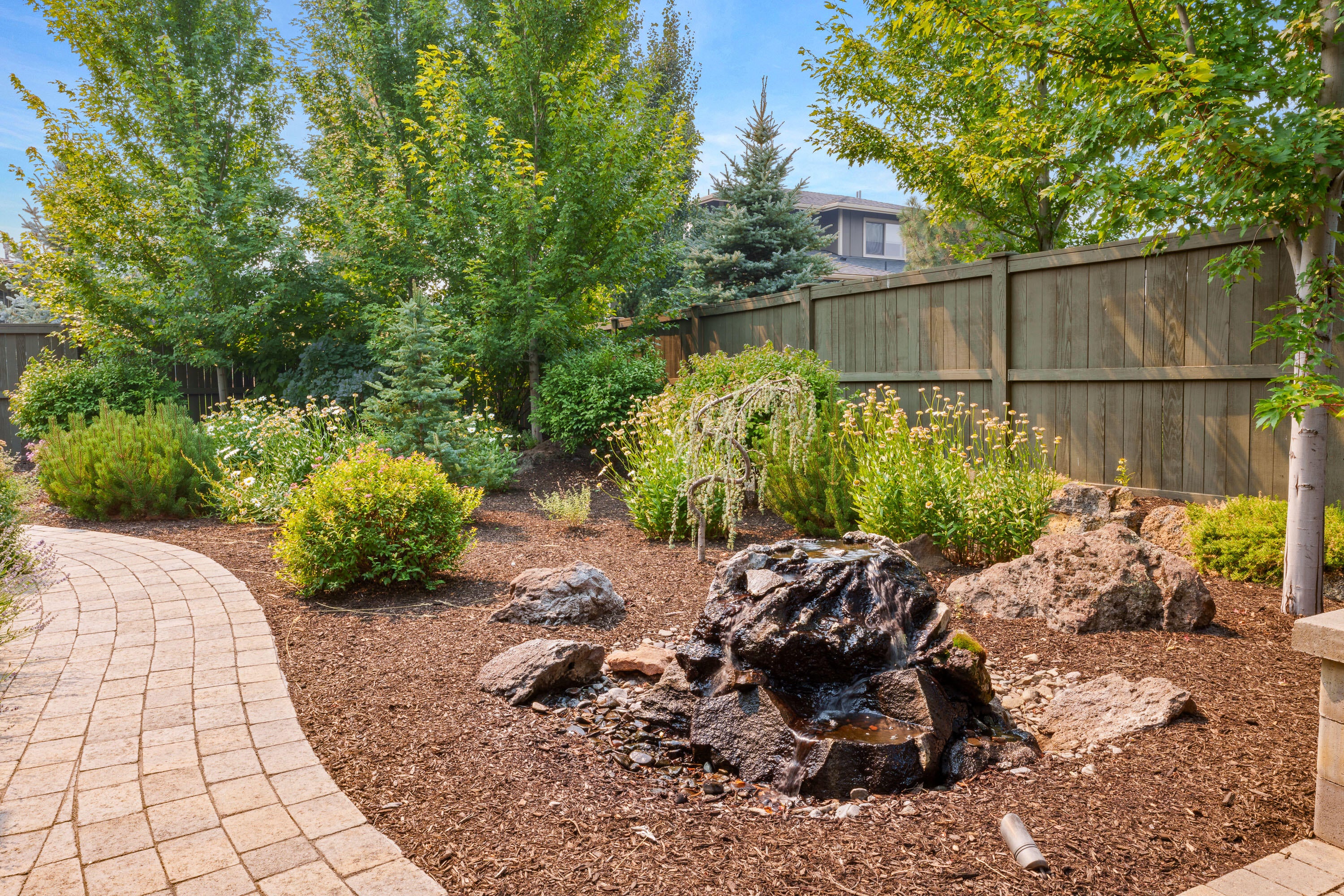 60869 Southwest Headwaters Loop Bend, OR 97702 - Photo 47 of 50 Backyard water feature adjacent to outdoor living space
