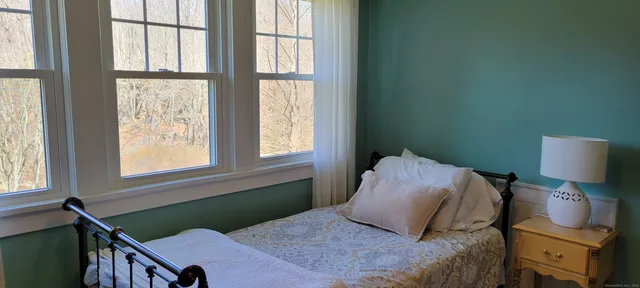 a bedroom with a bed and window