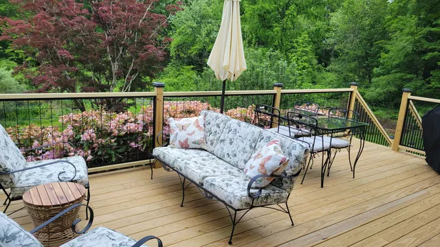a balcony with wooden floor potted plants